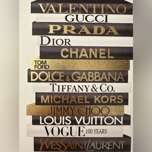 Canvas print black and gold designer name on book display.